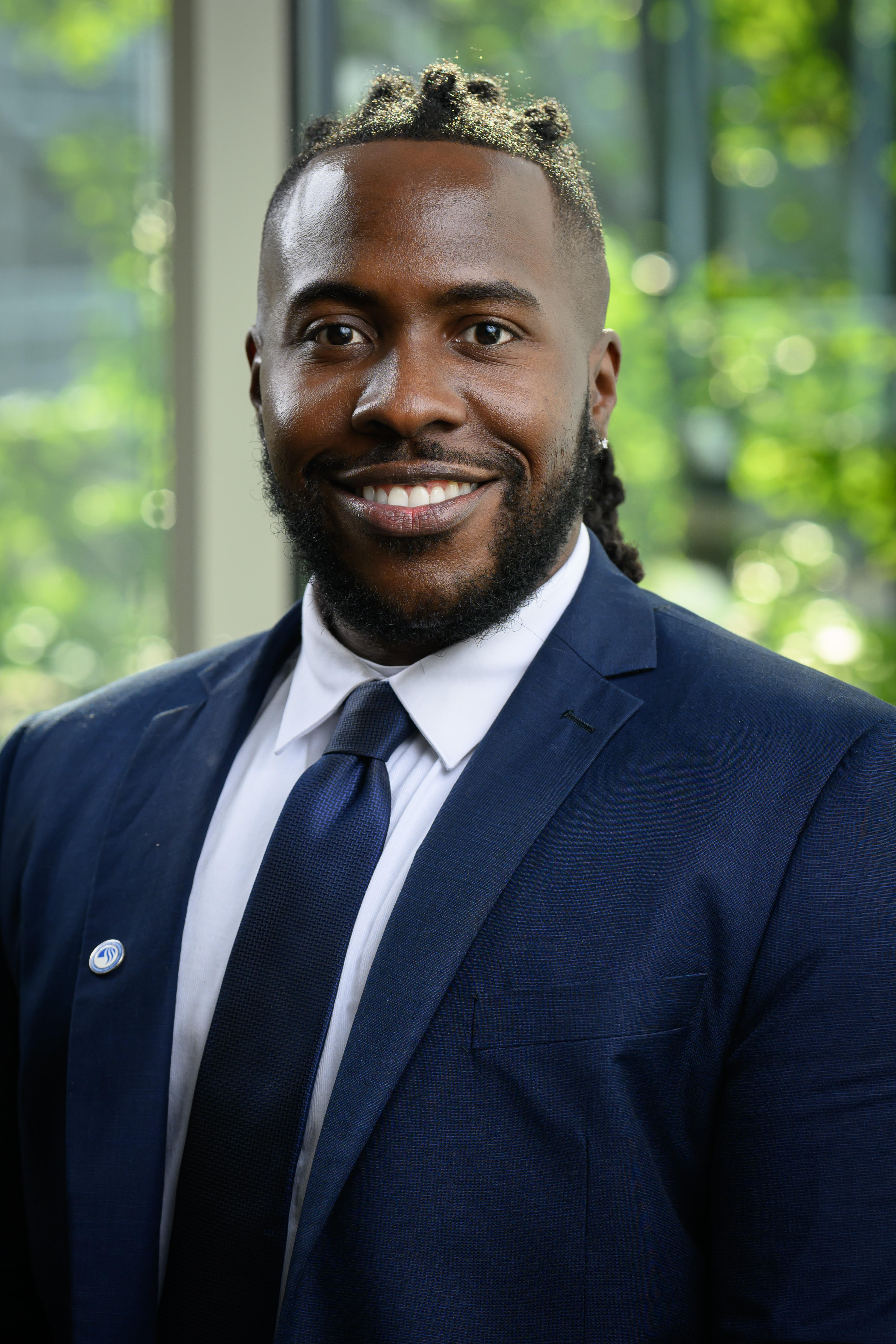 Tai Habersham wearing a navy suit and tie